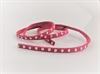  Imiteret læder bånd Cyklame farvet/ pink med nitter. Brug det til pynt omkring lys eller lav dit eget armbånd. Længde ca. 48 cm. Brede 0,5 cm.